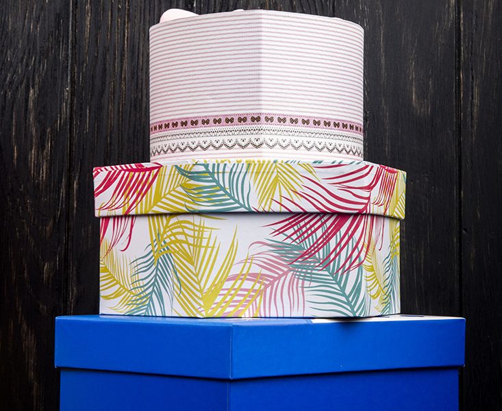 side view stack colorful present boxes dark wooden table