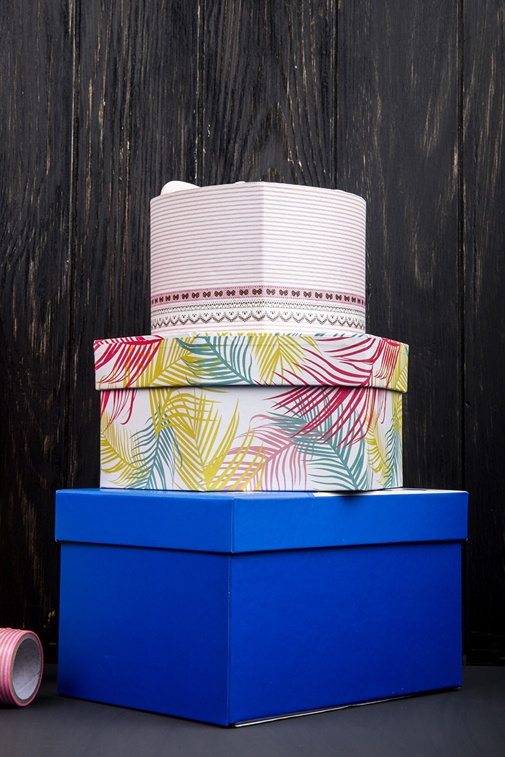 side view stack colorful present boxes dark wooden table